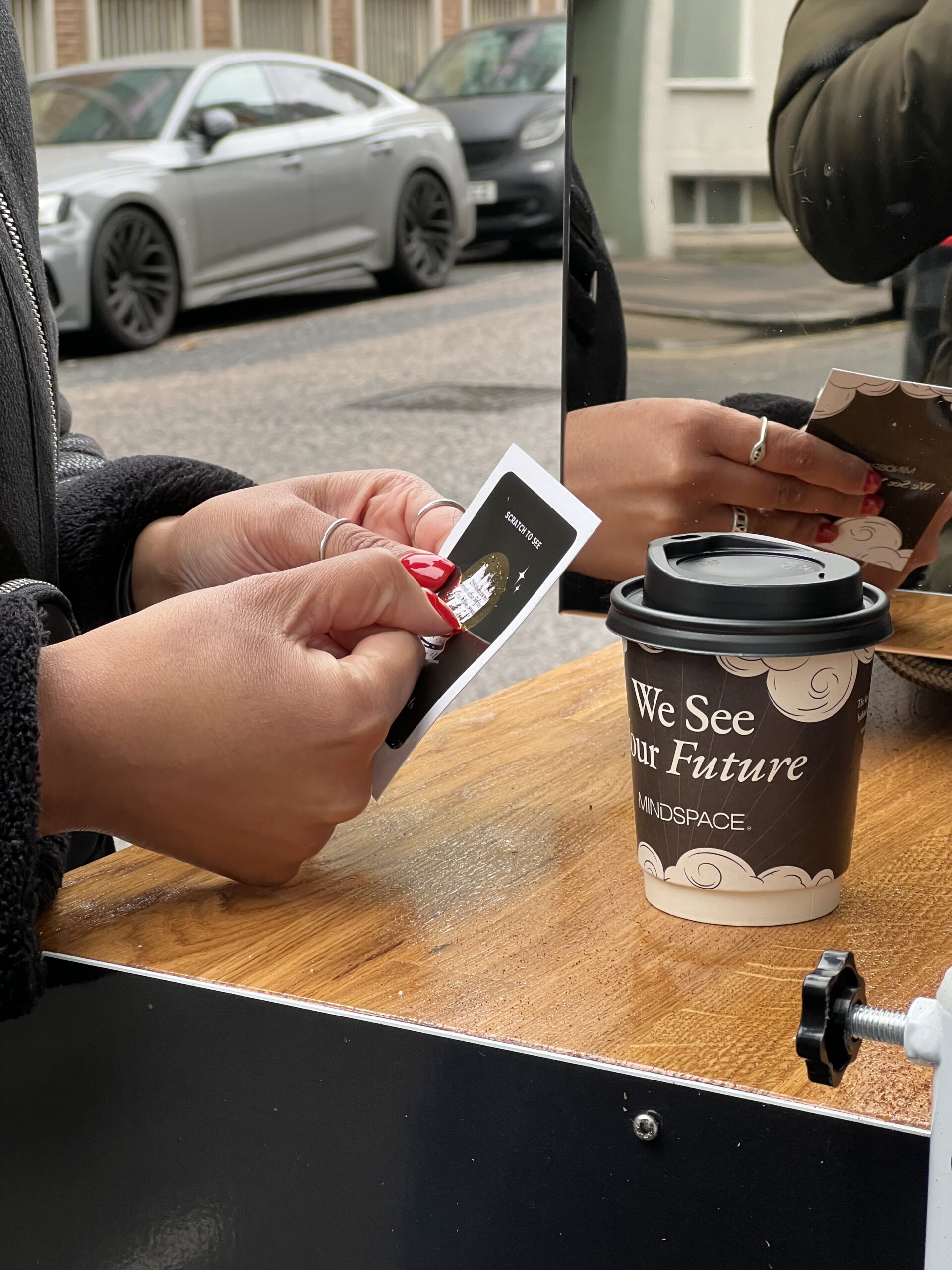 Customer scratching off card on street marketing campaign